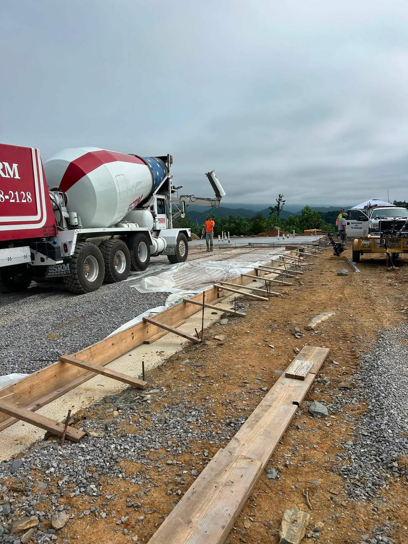 Ready-mix concrete truck pouring a large commercial project at a mountaintop site