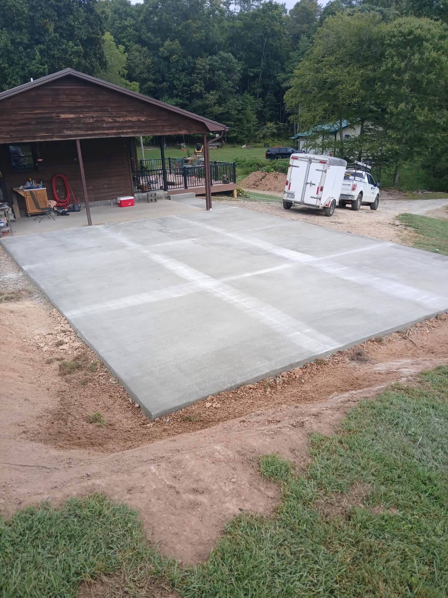 Large freshly finished concrete slab next to a workshop building in Abingdon, Virginia